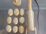 a display case with a wooden figure and a lot of buttons