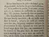 an old book with a page in the middle of it that has writing on it