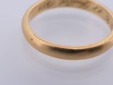 a close up of a gold ring on a white surface