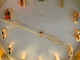 a gold clock with a white face and numbers on it