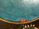 a close up of a blue bowl with gold designs on it