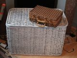 a wicker basket with a wicker bag on top of it