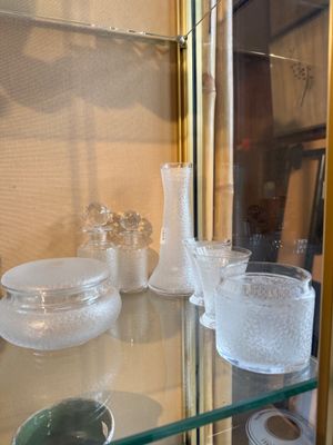 a glass display case with a lot of glass items on it