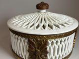 a white and gold box with a lid on a table