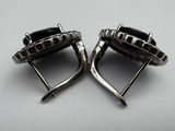 pair of silver tone cuff rings with a black stone in the center