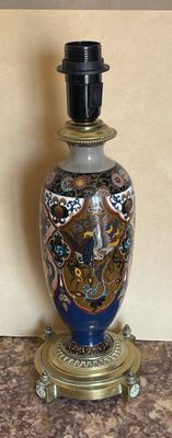 a blue and gold vase sitting on a table