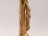 a gold statue of a woman holding a baby in her arms