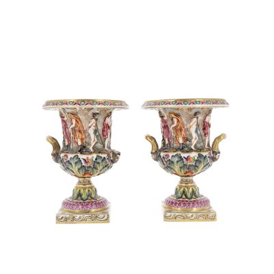 pair of vases with figures on them on a white background