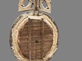 a wooden clock that has a bird on top of it