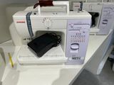 a sewing machine on a table with other sewing machines