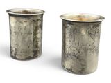 pair of antique silverplated cups with engraved names on them