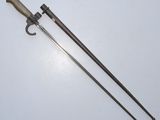 an old pair of swords with a wooden handle on a white surface