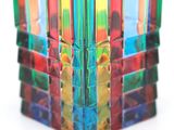 a multicolored glass vase sitting on a white surface
