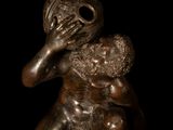 bronze statue of a man holding a child in his arms