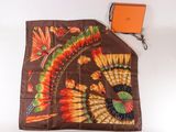 a scarf with a design on it next to an orange box