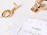 a gold ring and a pair of scissors on a table