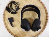 the headphones are sitting on a tray with a charger and cord
