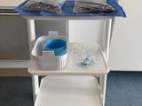 a white cart with a blue tray on top of it