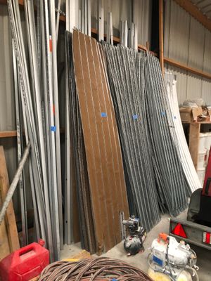 many different types of metal pipes and wires in a warehouse