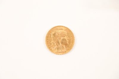 a close up of a gold coin on a white surface