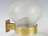 a glass light that is on the wall next to a wall light
