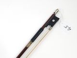 a violin bow and a violin stick on a white surface