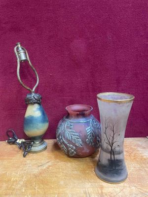 three vases and a lamp sitting on a table