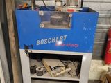 a blue machine that is sitting in a garage