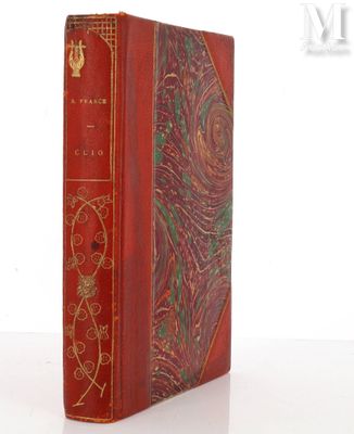 a red book with a gold trim and ornate design on the cover