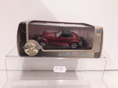 a red toy car in a clear box on a table
