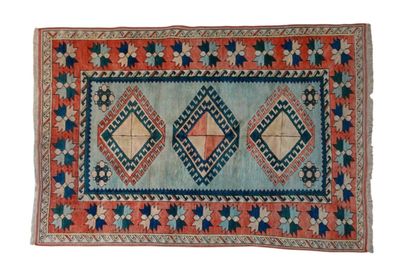 a blue and orange rug with a diamond design on it