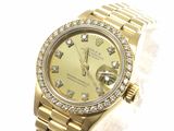 an image of a gold rolex watch with a diamond bezel