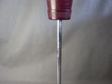 a red bucket on a metal stand with a handle
