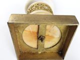 a picture of a gold clock with a chain on it