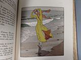 an open book with a picture of a woman walking on the beach