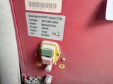 a red box with a digital meter attached to it