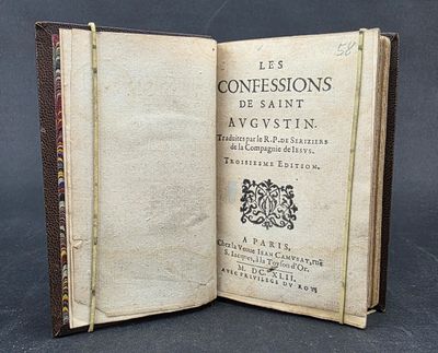 an old book opened to show the title of a poem