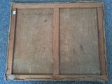 an old wooden frame with a glass window on top of a carpeted floor