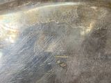 an image of a metal sculpture of a wave on a table