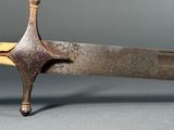 a very old knife that is sitting on a table