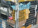 a large metal cage with a bunch of items in it