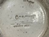 a close up of a white bowl on a table