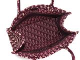 purple and white handbag on white background with strap