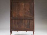 an old wooden cabinet with two doors and a drawer underneath it