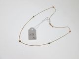a close up of a necklace with a tag attached to it