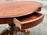 a wooden table with a drawer on top of it
