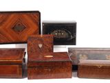 several wooden boxes are lined up on a white surface