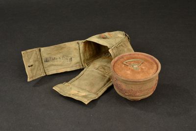 a small pot and a small bag on a table