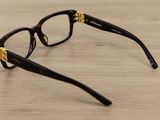 a pair of glasses sitting on a wooden table