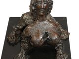 statue of a lion with a baby on its back on a black base